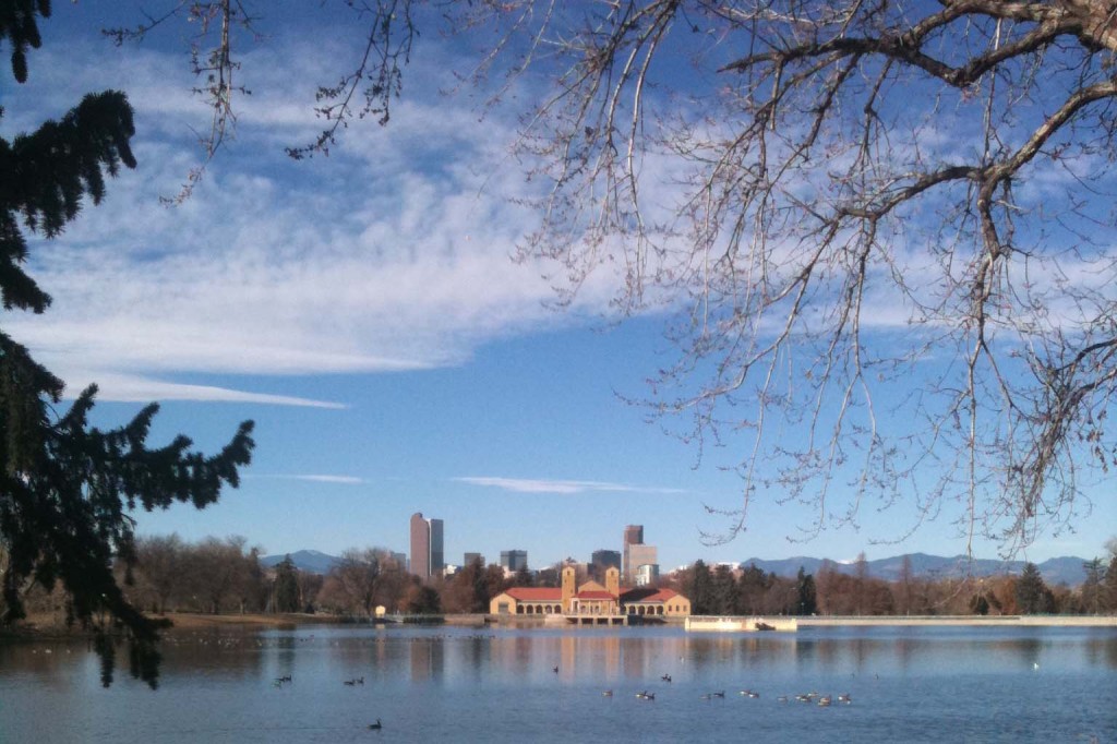 A view of the lake and skyline in Denver's City Park.